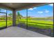 Screened porch with a view of the pond and green landscaping at 3118 Tramonto Ct, Bradenton, FL 34211