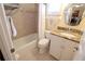 Bright bathroom with granite vanity, decorative mirror, tiled shower, and natural light at 3807 Lake Bayshore Dr # H-416, Bradenton, FL 34205