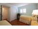 Cozy bedroom showcasing a twin bed, white closet doors, and a bright window with shutters at 3807 Lake Bayshore Dr # H-416, Bradenton, FL 34205