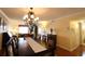 Open-concept dining area with chandelier and view into the living room at 3807 Lake Bayshore Dr # H-416, Bradenton, FL 34205