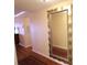 Hallway with hardwood floors and a large mirror at 3807 Lake Bayshore Dr # H-416, Bradenton, FL 34205