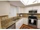 Kitchen with stainless steel appliances and granite countertops at 3807 Lake Bayshore Dr # H-416, Bradenton, FL 34205