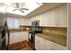 Bright kitchen featuring stainless steel appliances and granite counters at 3807 Lake Bayshore Dr # H-416, Bradenton, FL 34205