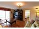 Bright living room with hardwood floors, entertainment center and sliding glass doors to balcony at 3807 Lake Bayshore Dr # H-416, Bradenton, FL 34205