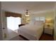 Main bedroom with king bed, ceiling fan and window with blinds at 3807 Lake Bayshore Dr # H-416, Bradenton, FL 34205