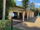 Exterior view of the clubhouse featuring an open patio, fans, and tables and chairs at 3810 75Th W St # 116, Bradenton, FL 34209