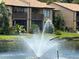 Condo building overlooks a lake with fountain and mature tropical landscaping with screened in balcony at 3810 75Th W St # 116, Bradenton, FL 34209