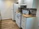 Bright kitchen featuring white appliances, a wood-look countertop, and stylish backsplash at 3810 75Th W St # 116, Bradenton, FL 34209