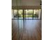 Spacious living room showcasing wood-look flooring and expansive glass doors leading to a balcony at 3810 75Th W St # 116, Bradenton, FL 34209
