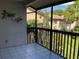 Outdoor patio with tiled flooring and black metal railings overlooking lush landscaping at 3810 75Th W St # 116, Bradenton, FL 34209