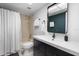 Modern bathroom featuring dark vanity with white countertop, an updated mirror, and shower with curtain at 4224 Madeira Ct # 3309, Sarasota, FL 34233
