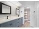 Modern bathroom featuring double sinks, updated fixtures, and a glass-enclosed shower at 4224 Madeira Ct # 3309, Sarasota, FL 34233