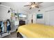 Bright bedroom featuring a ceiling fan, mounted TV, closet, and an open doorway at 4224 Madeira Ct # 3309, Sarasota, FL 34233