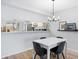 Dining area with modern table and chairs, open to the kitchen, ideal for Gathering meals and entertaining at 4224 Madeira Ct # 3309, Sarasota, FL 34233