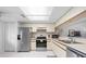 Bright kitchen with stainless steel appliances, white cabinetry, and a skylight, creating a welcoming space at 4224 Madeira Ct # 3309, Sarasota, FL 34233