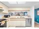 Modern kitchen showcasing stainless steel appliances, white cabinets, and an open layout, creating a functional space at 4224 Madeira Ct # 3309, Sarasota, FL 34233