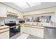 Open kitchen layout with stainless steel appliances and light wood cabinets, perfect for modern living at 4224 Madeira Ct # 3309, Sarasota, FL 34233
