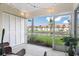 Relaxing screened-in lanai overlooking a pond with lush green landscaping at 4224 Madeira Ct # 3309, Sarasota, FL 34233