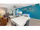 Open concept living area with dining area, blue accent wall, modern furniture, and plenty of natural light at 4224 Madeira Ct # 3309, Sarasota, FL 34233