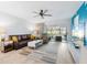 Bright living room featuring a leather sofa, ceiling fan, and sliding glass doors to the outside at 4224 Madeira Ct # 3309, Sarasota, FL 34233