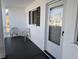 Inviting condo entrance featuring a tiled porch with two chairs and unit number displayed above the door at 5925 Todd St # D-21, Bradenton, FL 34207