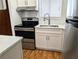 Modern kitchen with stainless steel appliances, white cabinets, laminate countertops, and stainless steel faucet at 5925 Todd St # D-21, Bradenton, FL 34207
