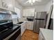 Updated kitchen with stainless steel appliances, new white cabinets and countertop, and modern fixtures at 5925 Todd St # D-21, Bradenton, FL 34207