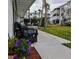 Charming patio area with wicker furniture, flower pots, lush landscaping and views of neighboring buildings at 5925 Todd St # D-21, Bradenton, FL 34207