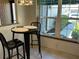 Bright breakfast nook with black table and chairs, offering a view of the outdoors at 5956 Clubside Dr # 7651, Sarasota, FL 34243