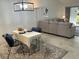 Inviting living room showcasing a comfortable sectional sofa, decorative pillows, and tile floors at 5956 Clubside Dr # 7651, Sarasota, FL 34243