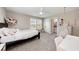 Bright bedroom with a comfy bed, built-in shelves, and plenty of natural light at 3360 Chestertown Loop, Bradenton, FL 34211
