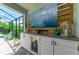 Outdoor kitchen with large TV and beverage cooler at 3360 Chestertown Loop, Bradenton, FL 34211