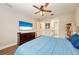 Spacious bedroom with wood-look floors, large TV, and ample closet space at 3360 Chestertown Loop, Bradenton, FL 34211