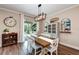Farmhouse-style dining room with wooden table and view of the pool at 3360 Chestertown Loop, Bradenton, FL 34211
