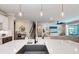Modern kitchen with large island, white cabinets, and a farmhouse sink at 3360 Chestertown Loop, Bradenton, FL 34211