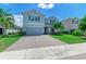 Two-story house with gray siding, paver driveway and palm trees at 3360 Chestertown Loop, Bradenton, FL 34211