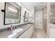 Modern bathroom with double vanity, large mirror, and a walk-in shower at 3360 Chestertown Loop, Bradenton, FL 34211
