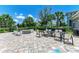 Outdoor kitchen and dining area with fire pit at 3360 Chestertown Loop, Bradenton, FL 34211