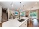 Open concept kitchen with island, stainless steel sink and breakfast bar at 3360 Chestertown Loop, Bradenton, FL 34211