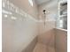 Walk-in shower with neutral tile and a rainfall shower head at 3360 Chestertown Loop, Bradenton, FL 34211