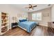 Spacious bedroom with wood floors, ceiling fan, and plenty of natural light at 3360 Chestertown Loop, Bradenton, FL 34211