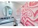 Clean bathroom with a toilet, sink, and pink patterned shower curtain at 3360 Chestertown Loop, Bradenton, FL 34211