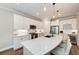 White kitchen with stainless steel appliances and large island at 3360 Chestertown Loop, Bradenton, FL 34211
