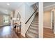 Light and airy entryway with a stylish console table and carpeted stairs at 3360 Chestertown Loop, Bradenton, FL 34211