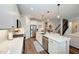Modern kitchen features white cabinets, stainless steel appliances, and a large island at 3360 Chestertown Loop, Bradenton, FL 34211