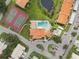 Aerial view of community pool, tennis court, and clubhouse at 4224 Madeira Ct # 3309, Sarasota, FL 34233