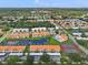 Aerial view of condo community with tennis courts, pool, and pond at 4224 Madeira Ct # 3309, Sarasota, FL 34233