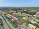 Aerial view of condo community with tennis courts, pool, and pond at 4224 Madeira Ct # 3309, Sarasota, FL 34233