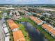 Aerial view of community with pond and tennis court at 4224 Madeira Ct # 3309, Sarasota, FL 34233