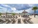 Beach with lounge chairs and a tiki hut at 16633 Mooner Plank Cir, Wimauma, FL 33598